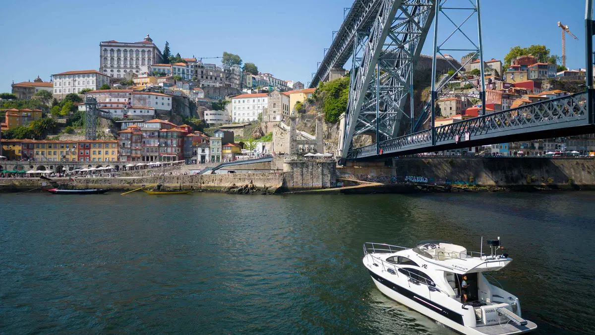 Boat on the Douro River under Porto's bridges on a port wine river cruise with 4 tastings, Portugal