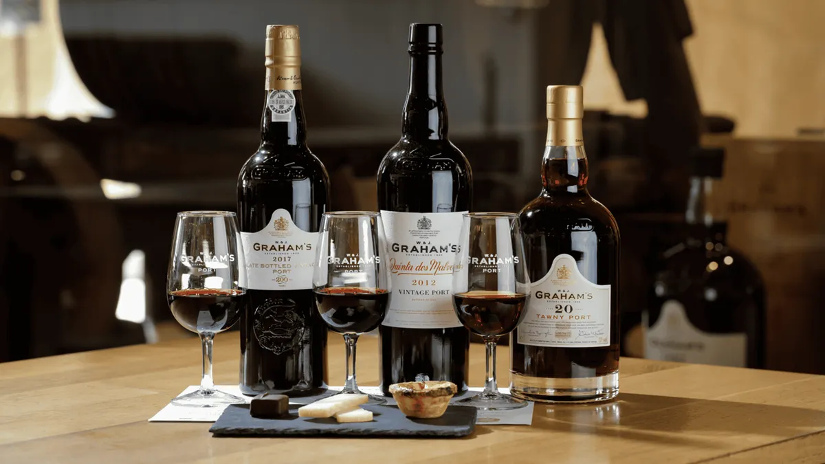 Graham's Port Lodge oak casks and terrace view of Porto on a port wine tour in Vila Nova de Gaia, Portugal