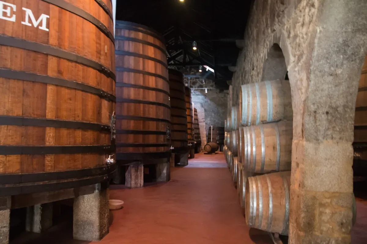 Oak tuns inside the Cálem cellars on a Cálem port cellar tour in Vila Nova de Gaia, Porto