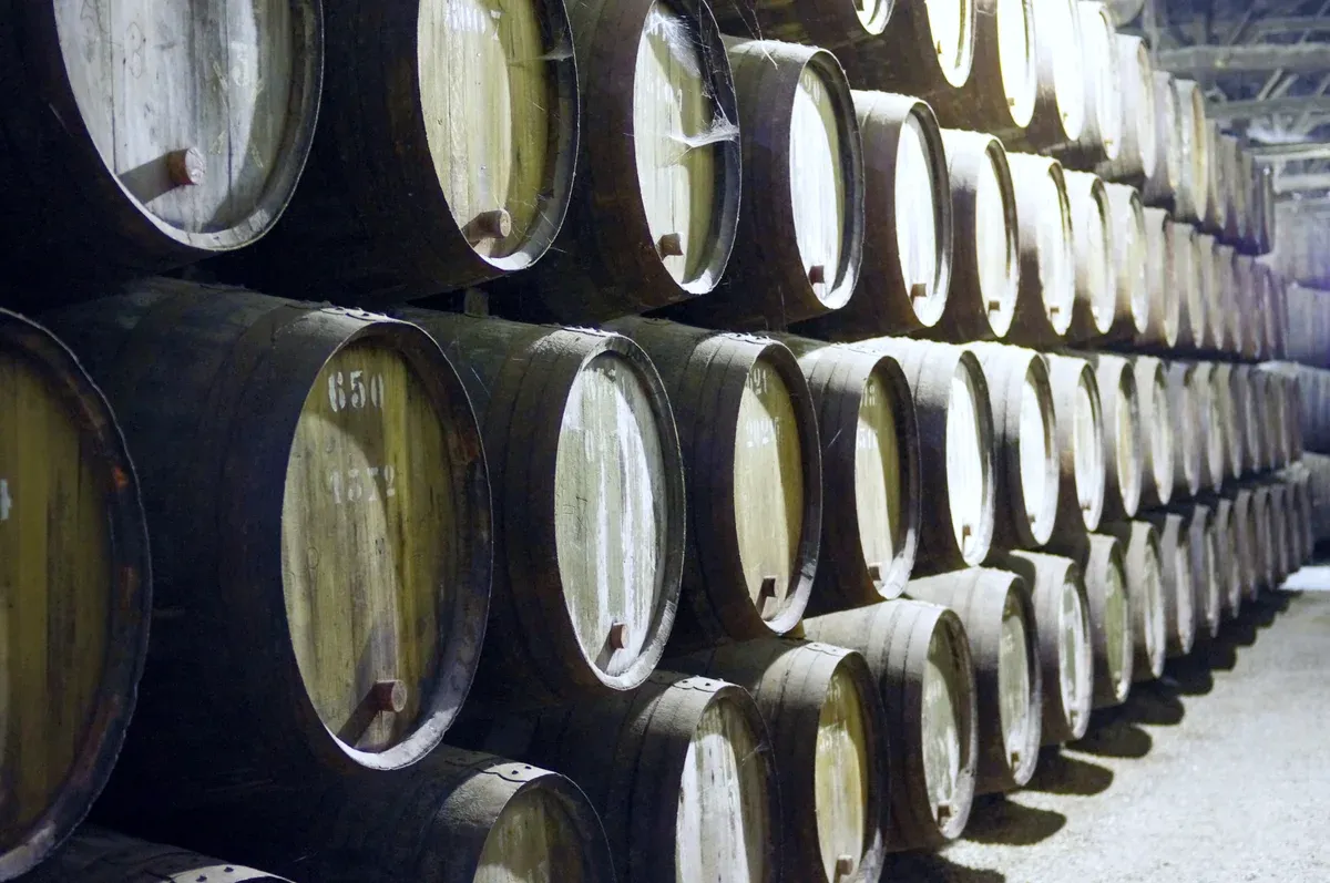 Stacked port barrels in a Gaia cellar visited on a port wine cellars tour of three cellars in Porto
