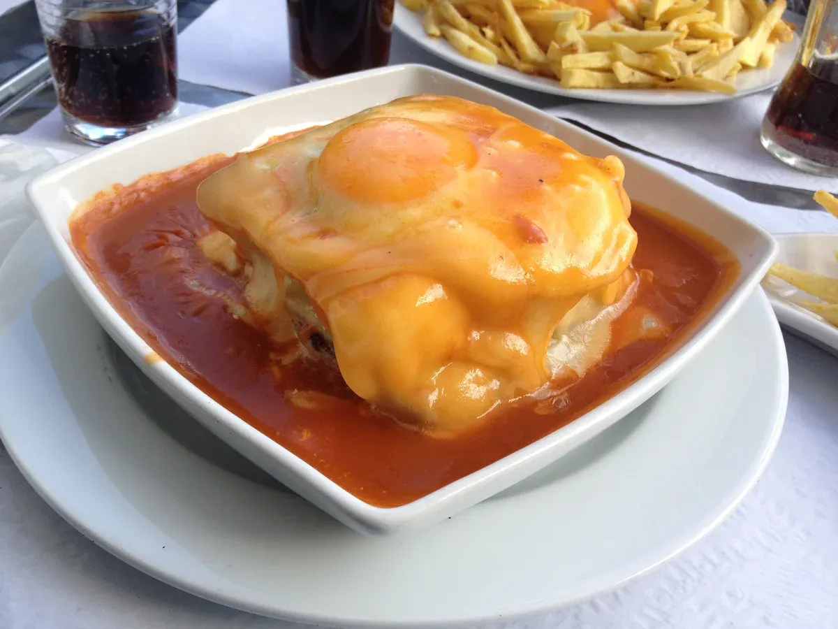 Francesinha especial with a fried egg, a stop on a Porto food and wine walking tour