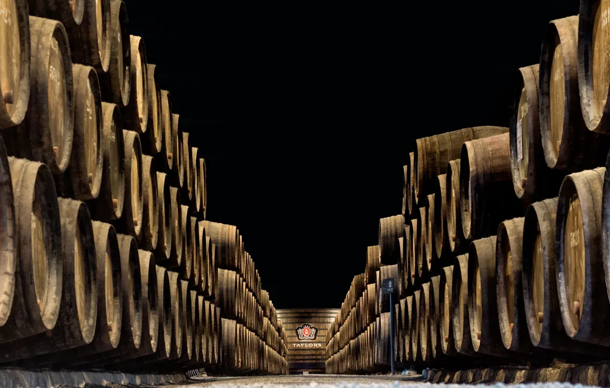 Barrel-lined corridor inside Taylor's cellars on a Taylor's port cellar tour in Vila Nova de Gaia